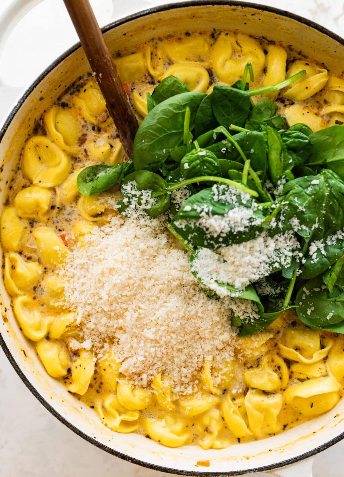 add spinach and cheese to the soup pot.