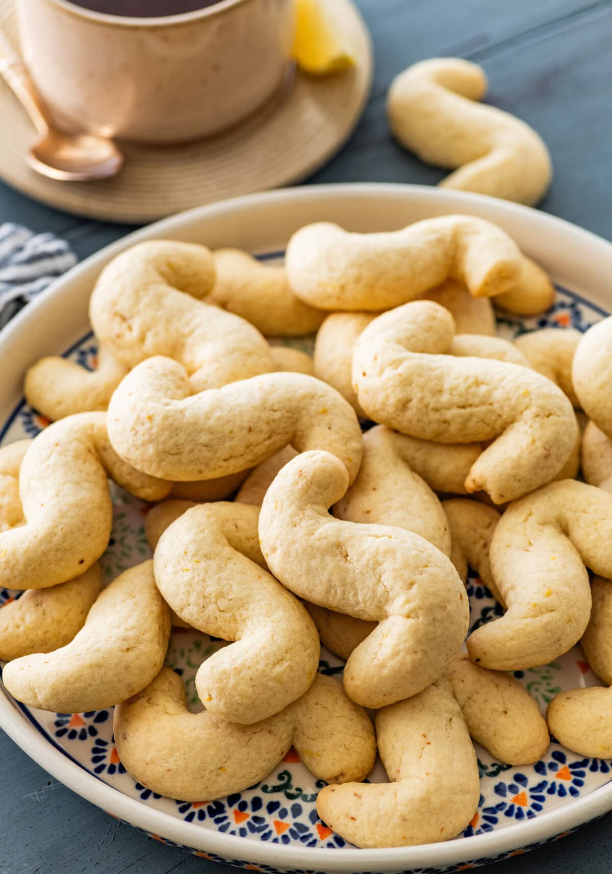 Beautiful Italian tray of Italian S cookies with a cup of tea on the side.