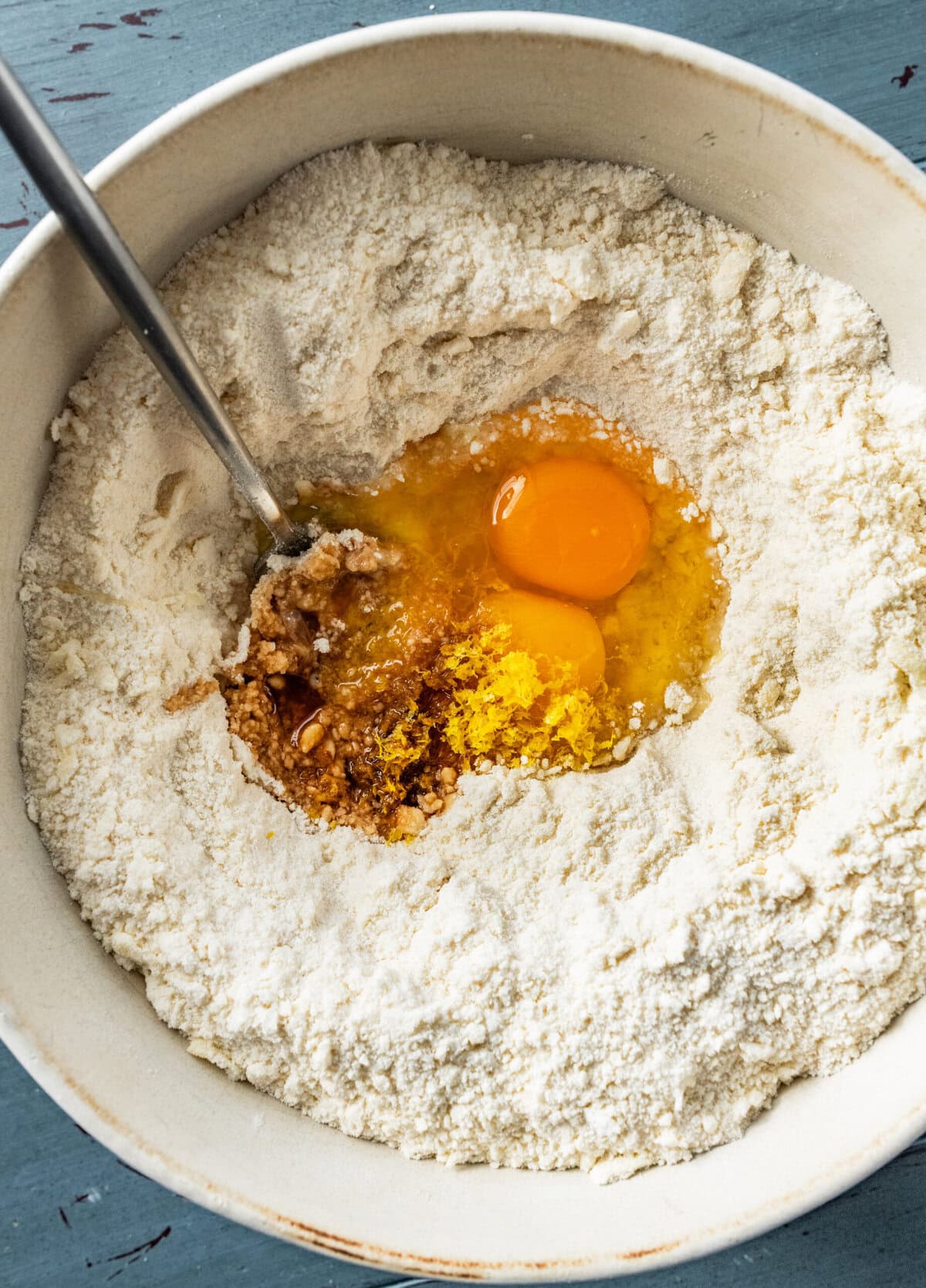 Egg and zest in the bowl with flour and butter.