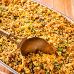 savory sweet potato casserole with a spoon taking out a portion.