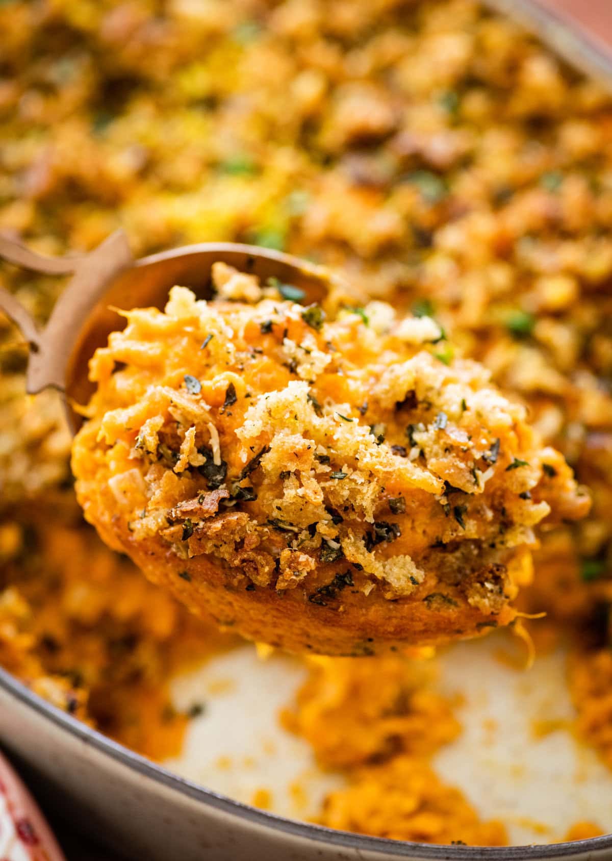 spoonful of the savory sweet potato casserole on a spoon.