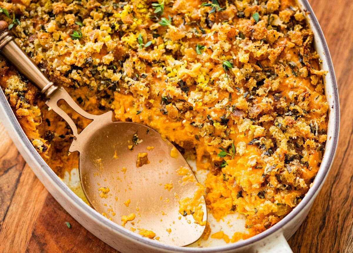 savory sweet potato casserole with a spoon taking out a portion.