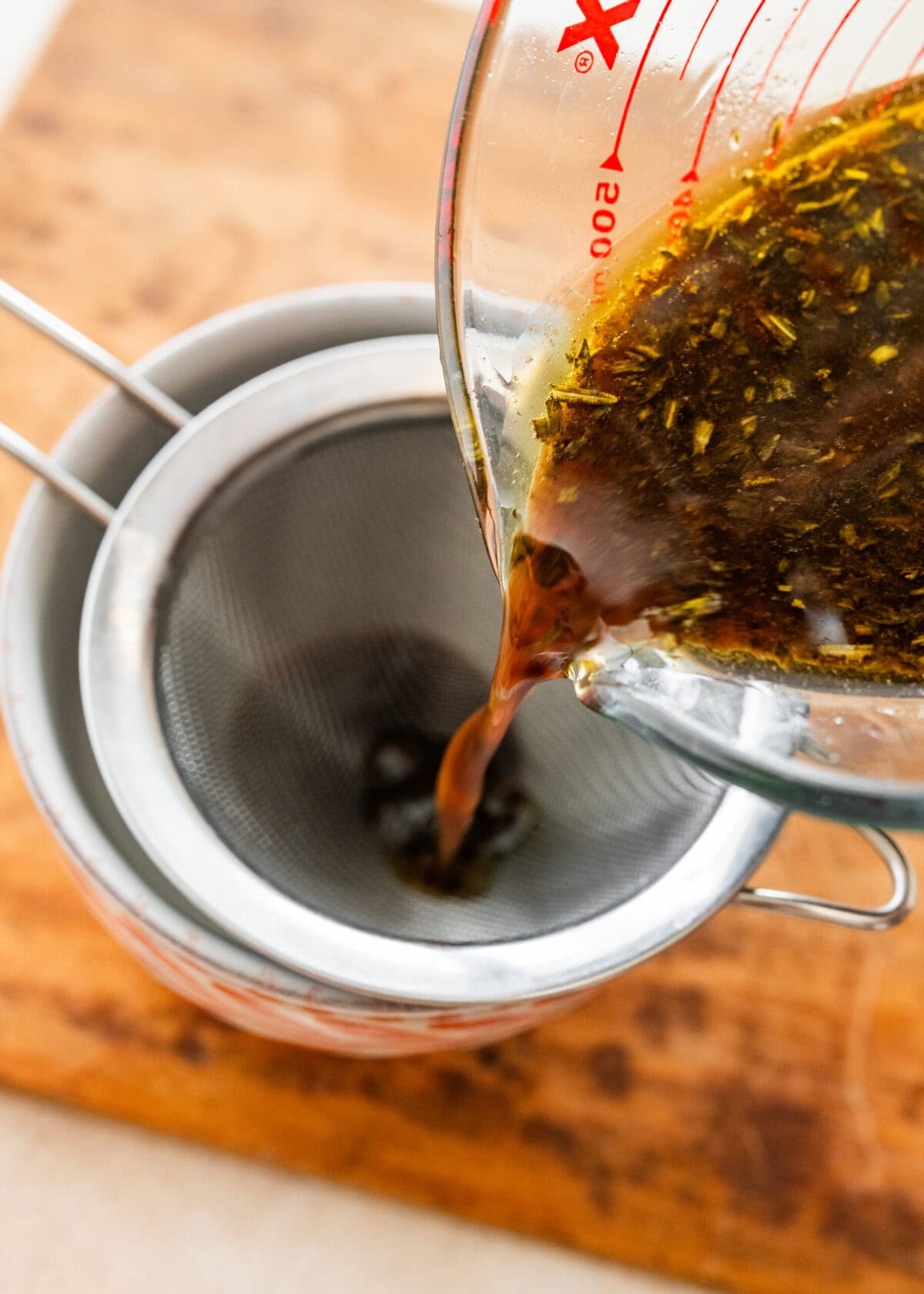 straining pan liquids to make au jus for the standing prime rib roast recipe.
