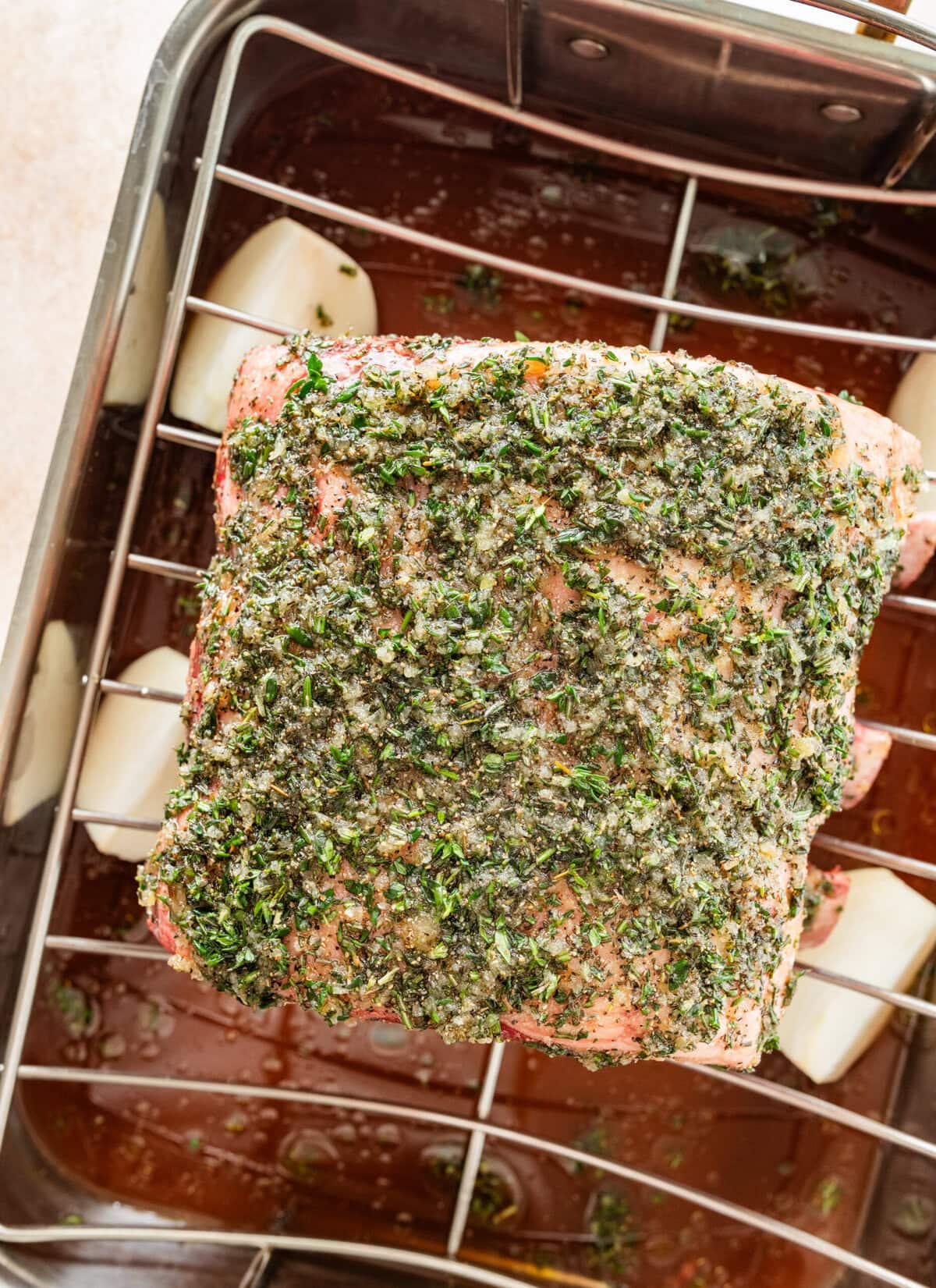 standing prime rib roast in the roasting pan before roasting.