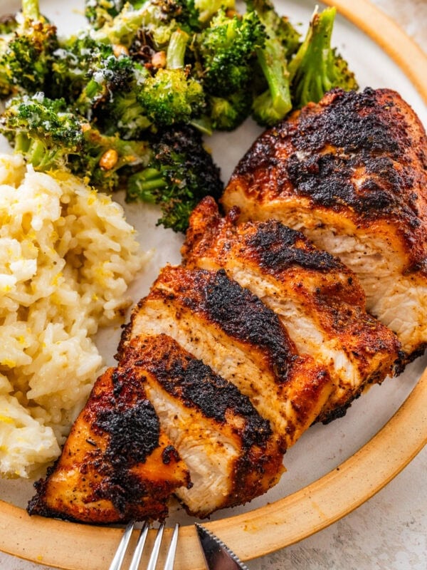 super juicy blackened chicken in a plate with lemon rice and broccoli.