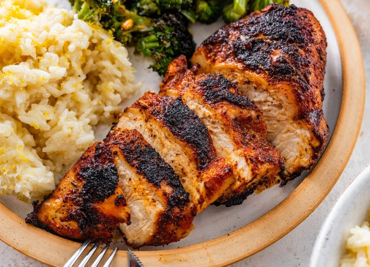 super juicy blackened chicken in a plate with lemon rice and broccoli.