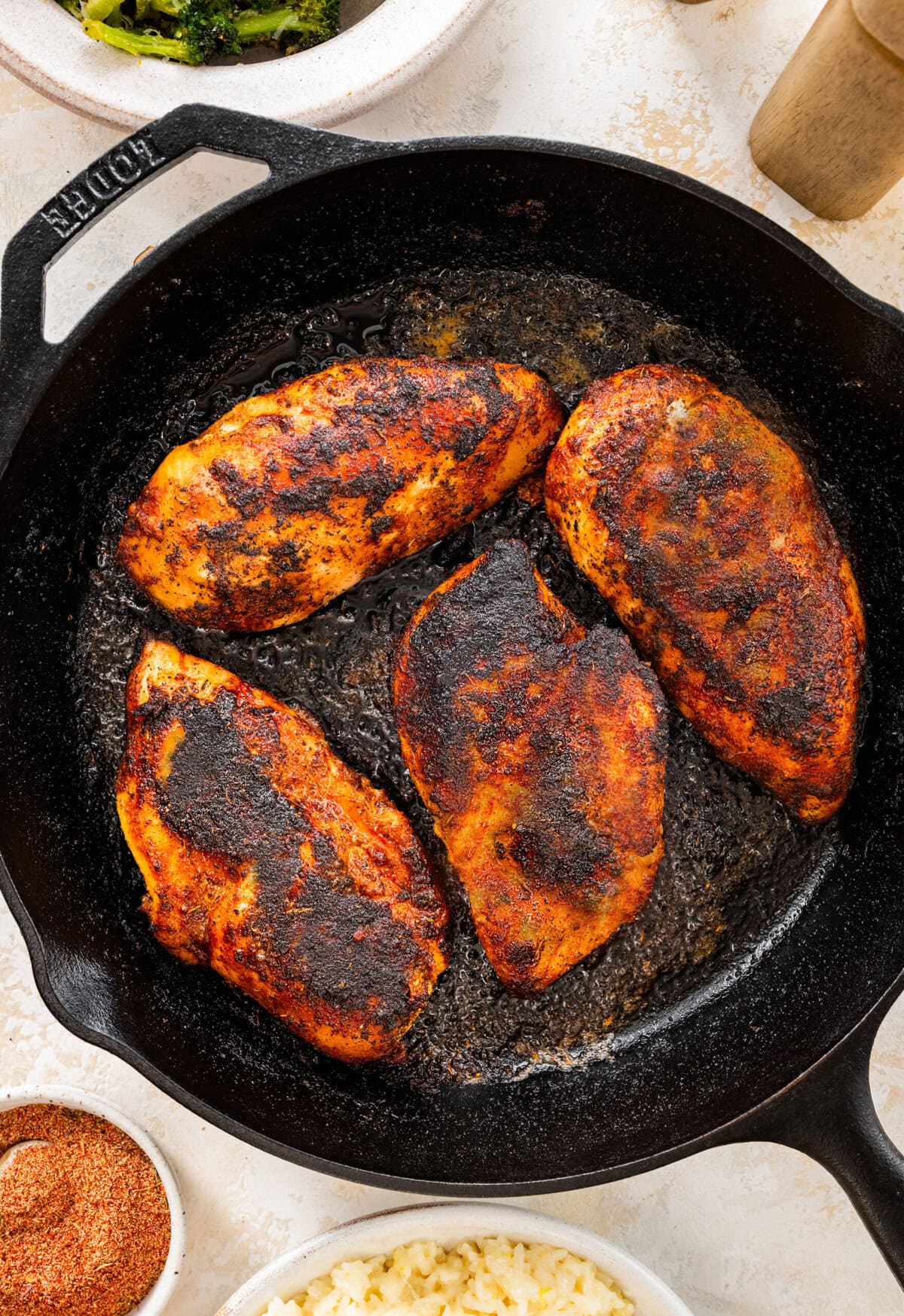 blackened chicken on cast iron pan with perfect sear on all sides.