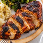 blackened chicken in a plate with lemon rice and broccoli.