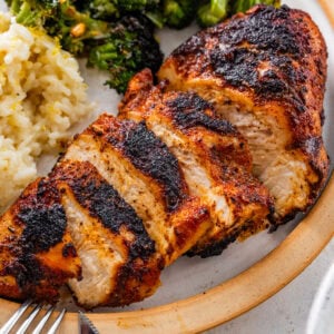 blackened chicken in a plate with lemon rice and broccoli.