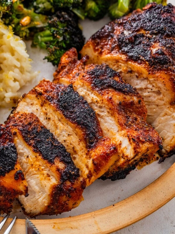 blackened chicken in a plate with lemon rice and broccoli.