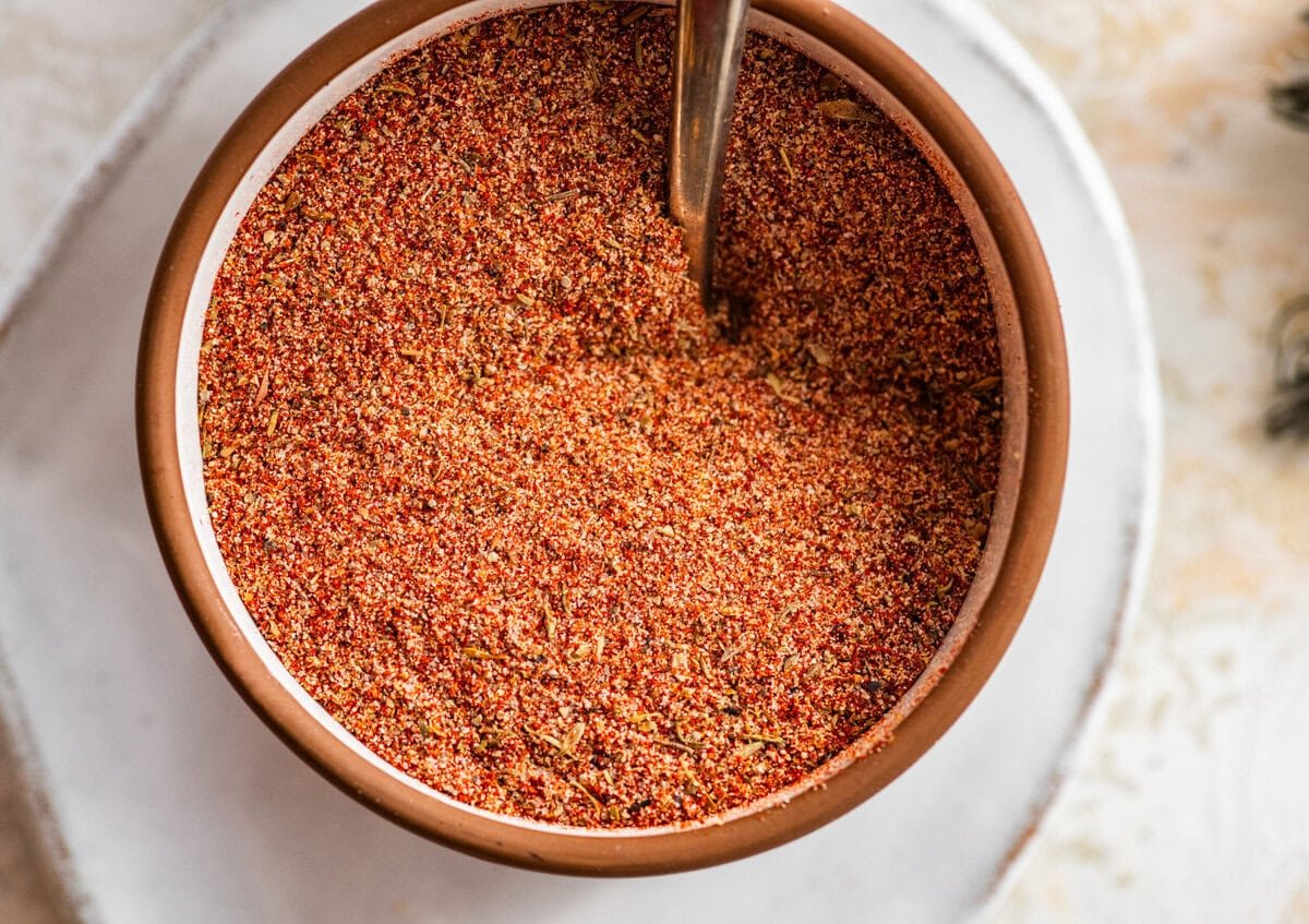 blackened seasoning in a white bowl with a spoon in it.