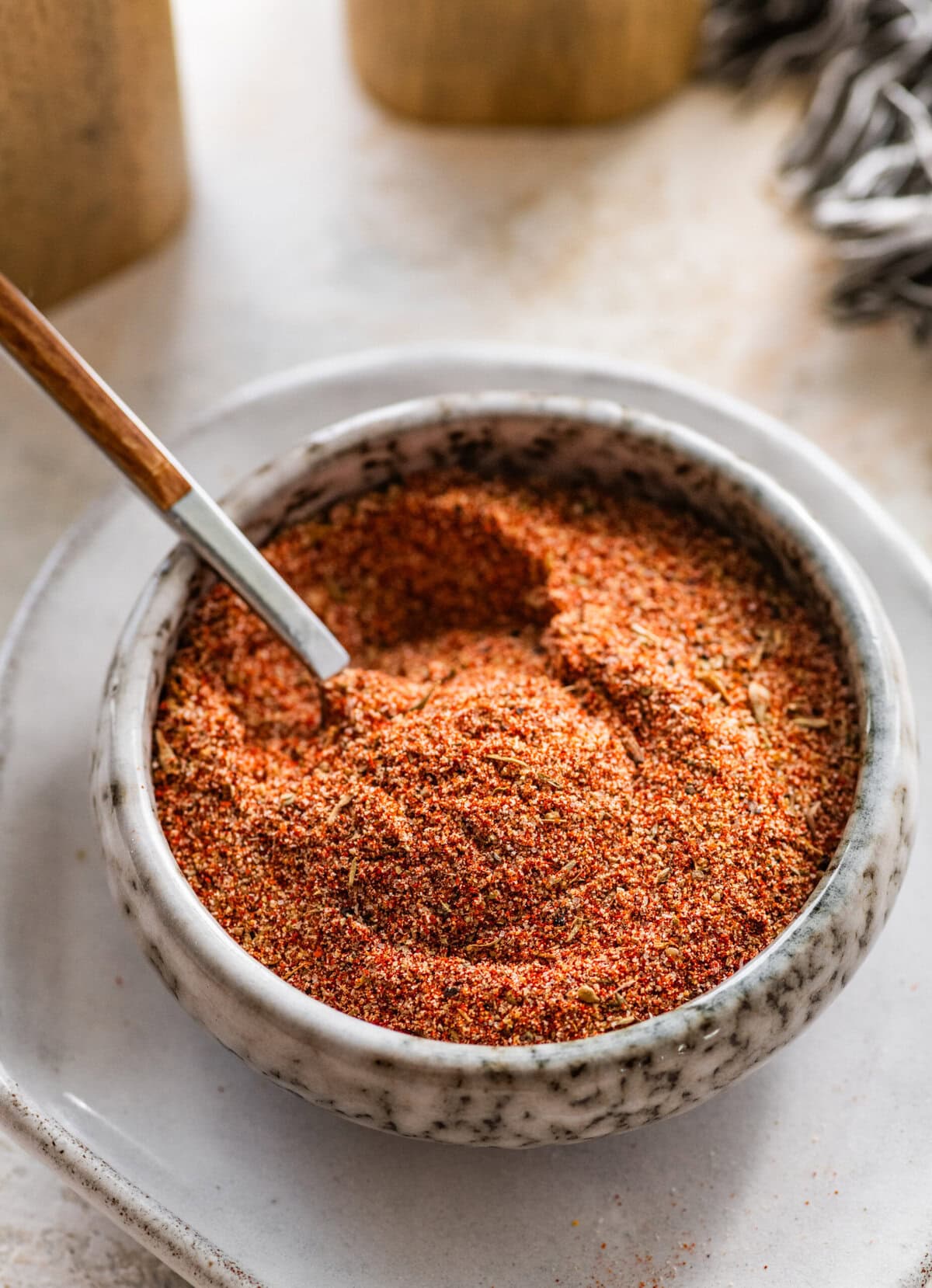 blackened seasoning in a white bowl with a spoon in it.