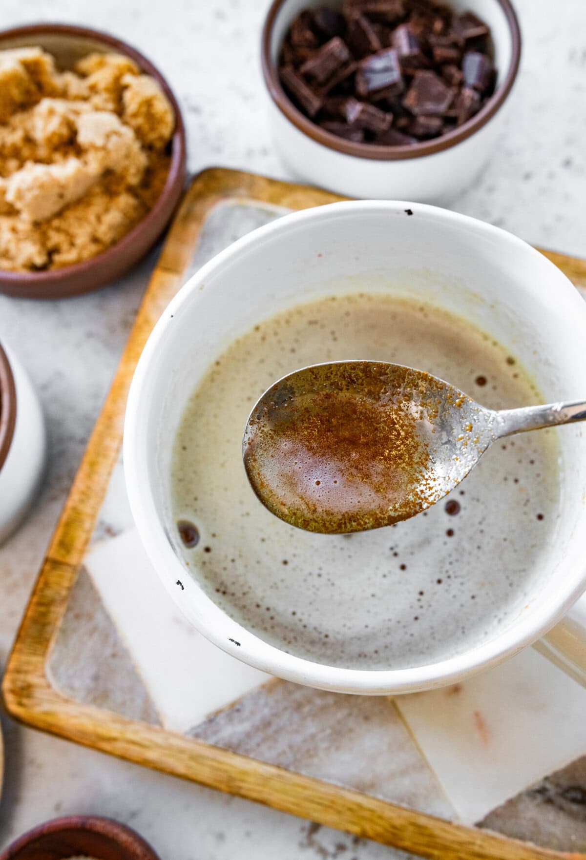 brown butter on a spoon over a bowl.
