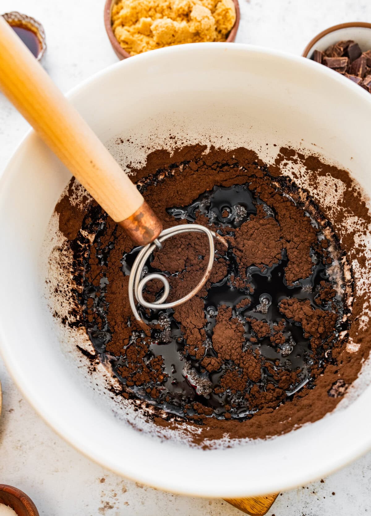 mixing cocoa powder into the brown butter with a whisk.