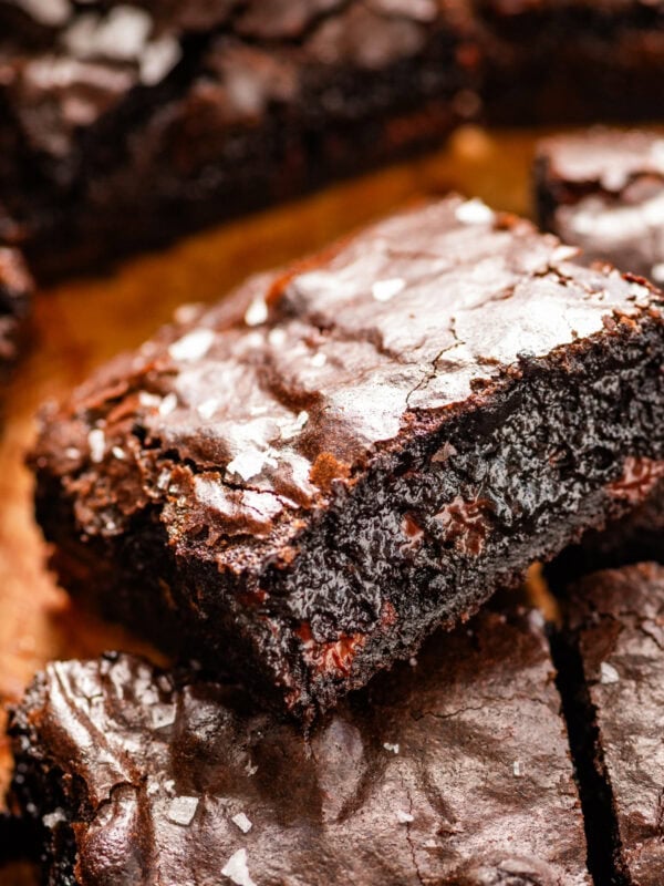 brown butter brownies cut into squares on parchments paper. sprinkle of flake salt on the top.