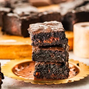brown butter brownies stacked on a plate ready to eat.
