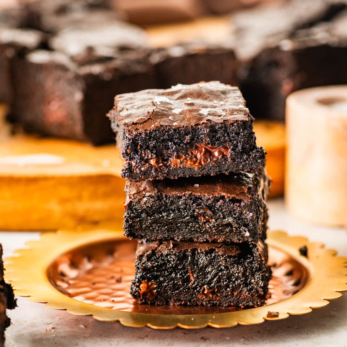 brown butter brownies stacked on a plate ready to eat.