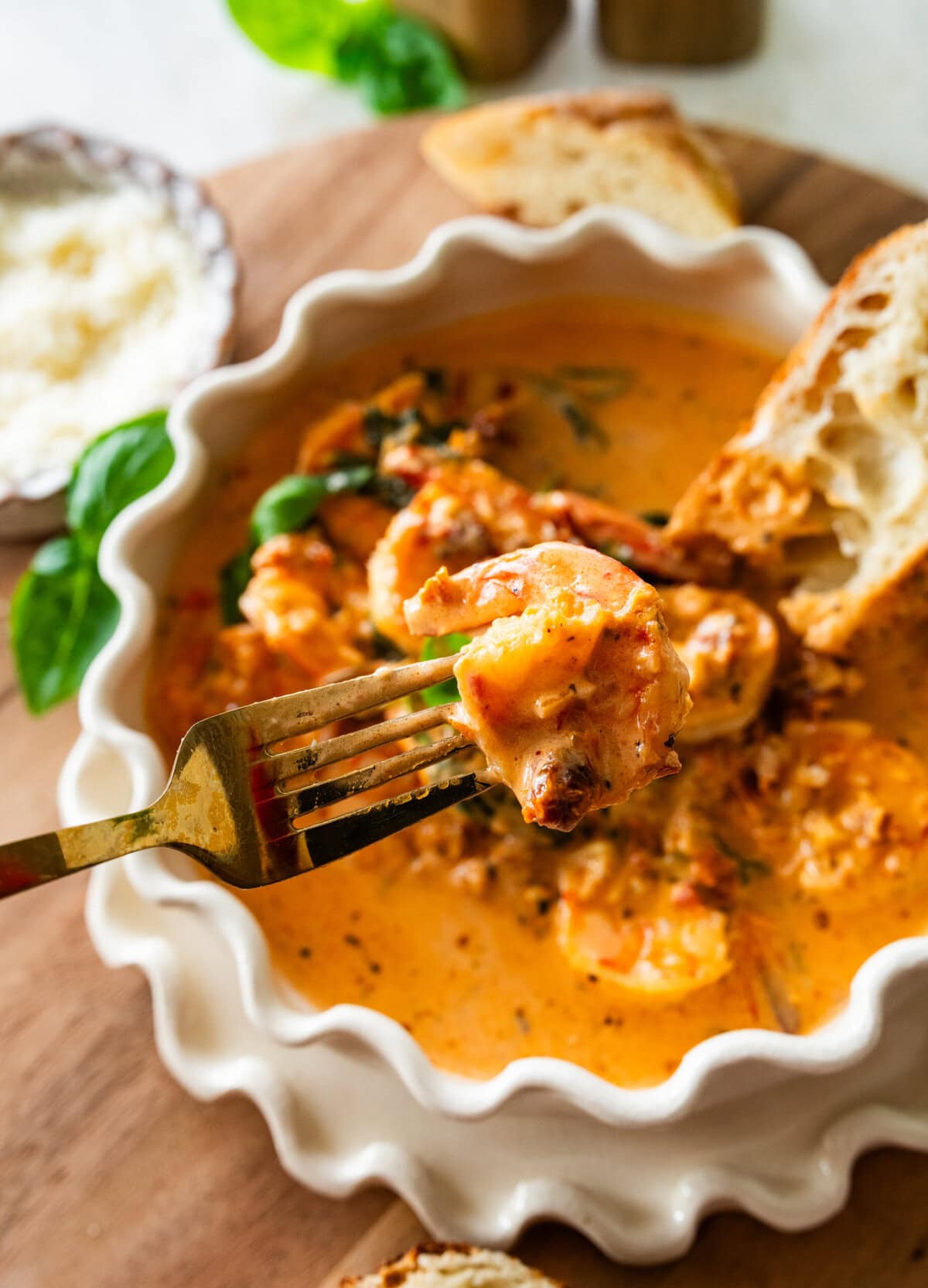 bowl of marry me shrimp with fork and bread in it ready to eat.