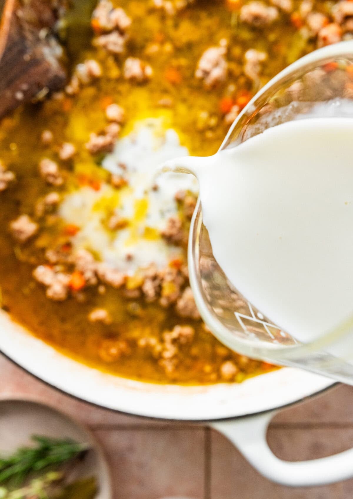 pour cream into pan with meats and veggies.