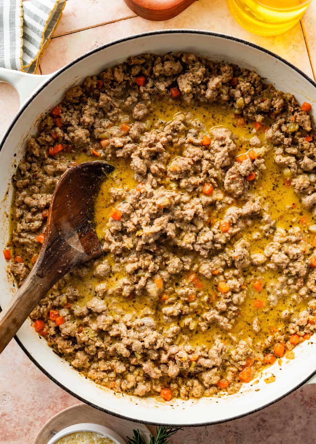 cooked white bolognese sauce in a large pot with a wooden spoon in it.
