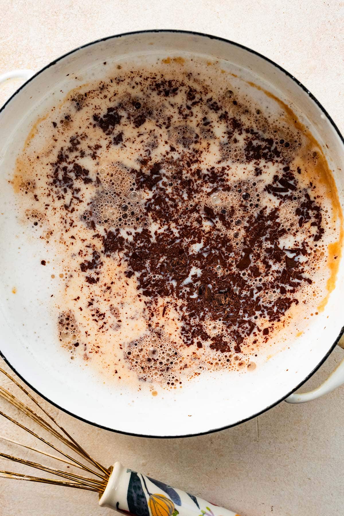 adding chopped chocolate and vanilla to the milk mixture.