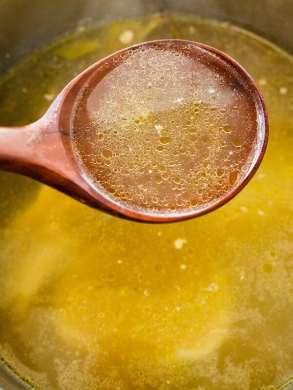homemade broth in a ladle.
