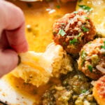 Dipping bread into the chicken piccata meatball sauce.
