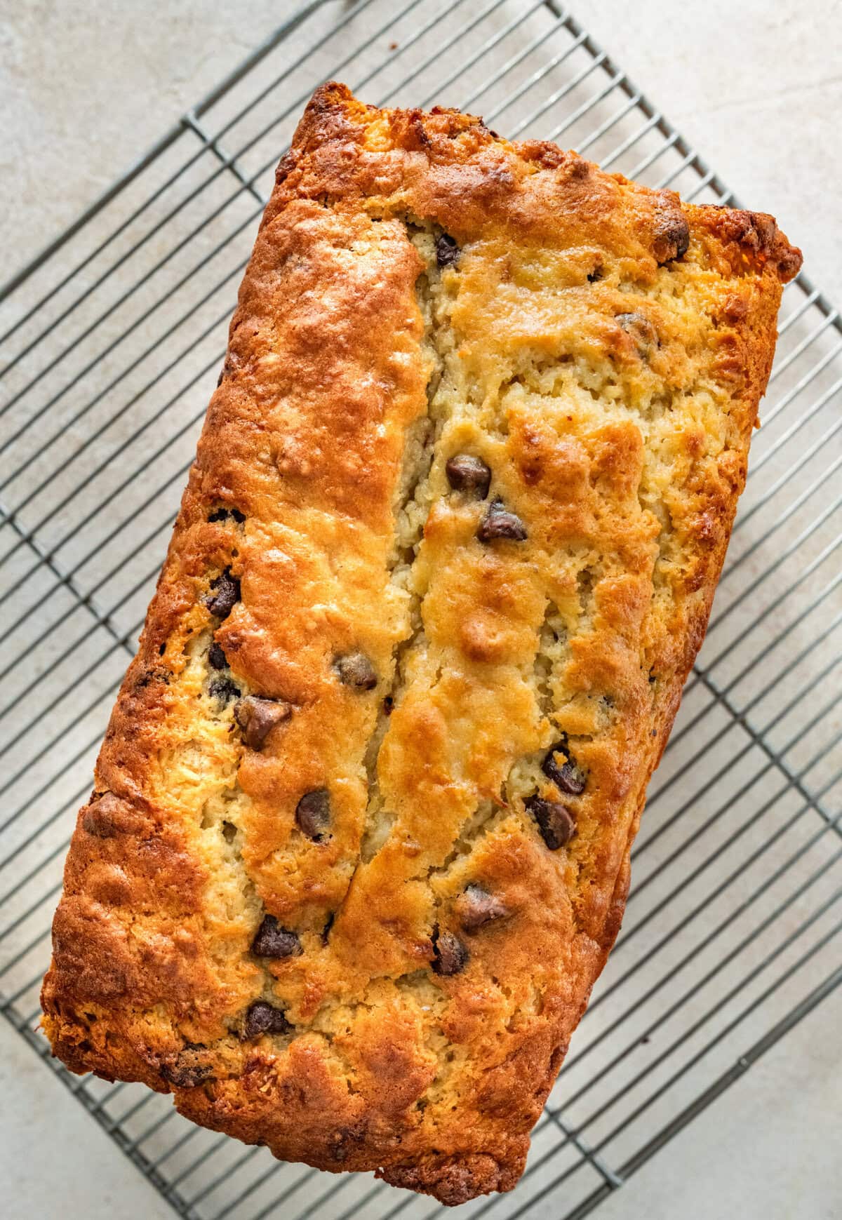 Chocolate chip banana bread with a horizontal score, after baking.