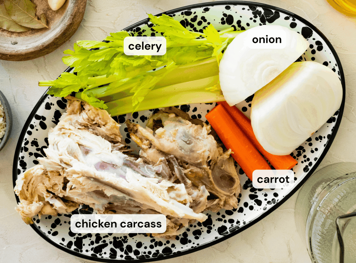 Ingredients to make chicken broth laid out on a plate.