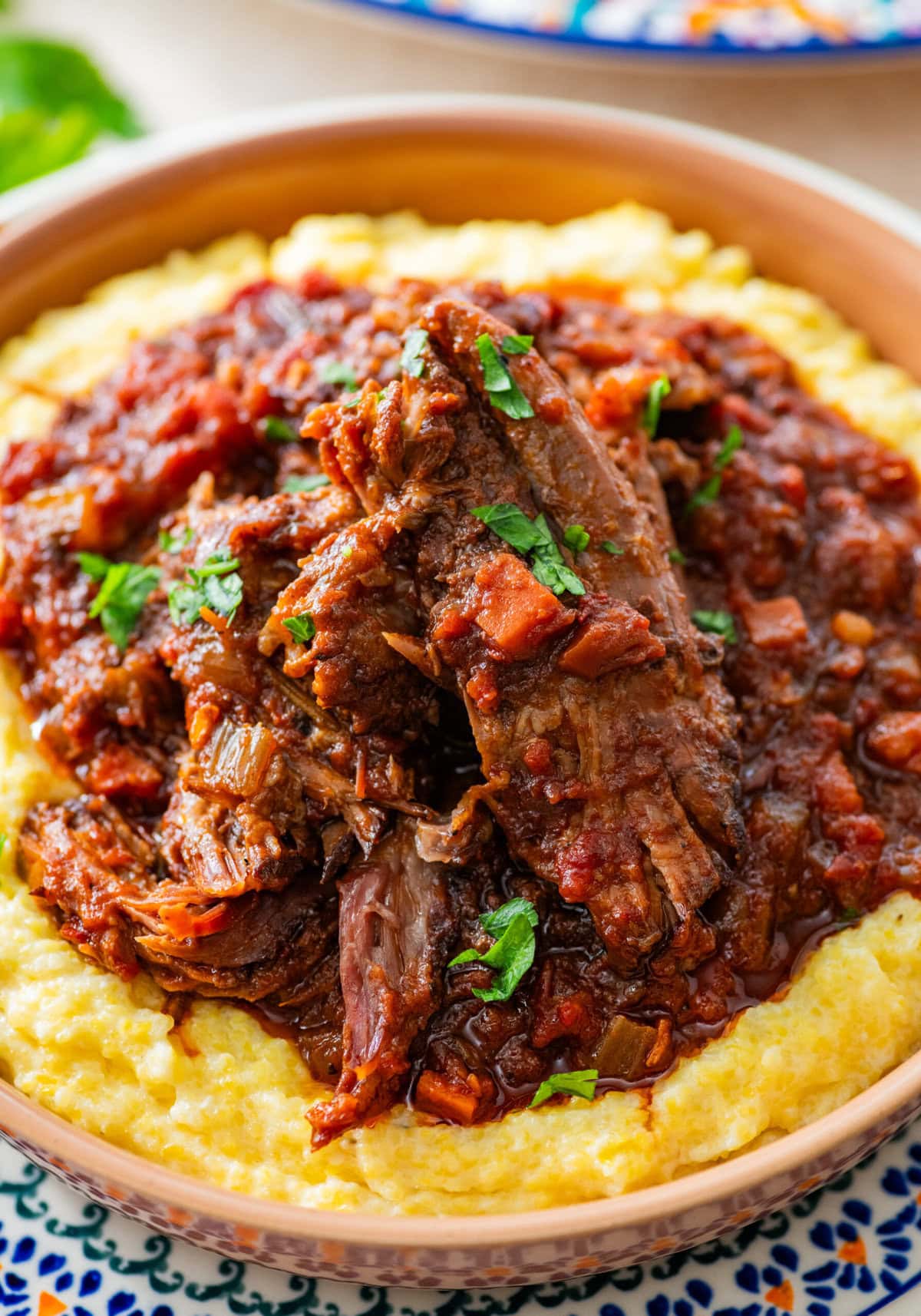 Italian pot roast plated on top of polenta.