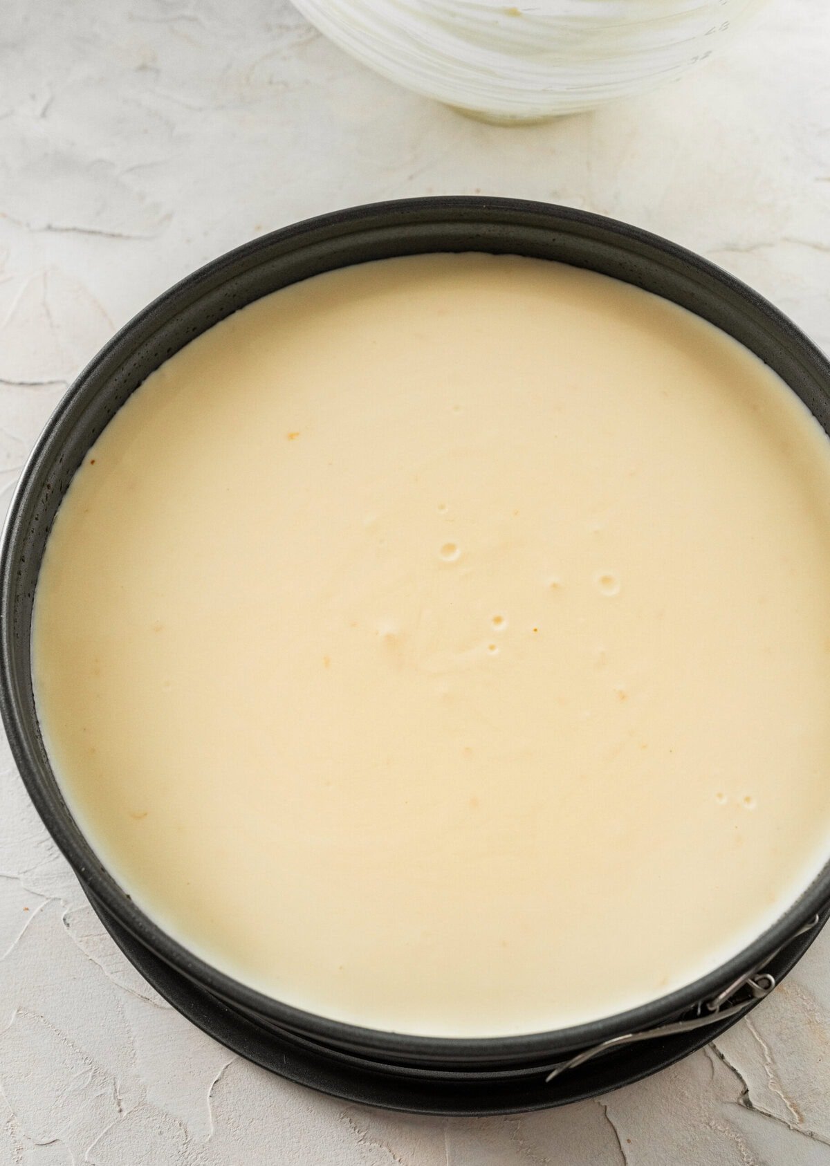 ricotta cheesecake with a smooth top in a springform pan.