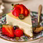 a slice of ricotta cheesecake topped and plated with berries.