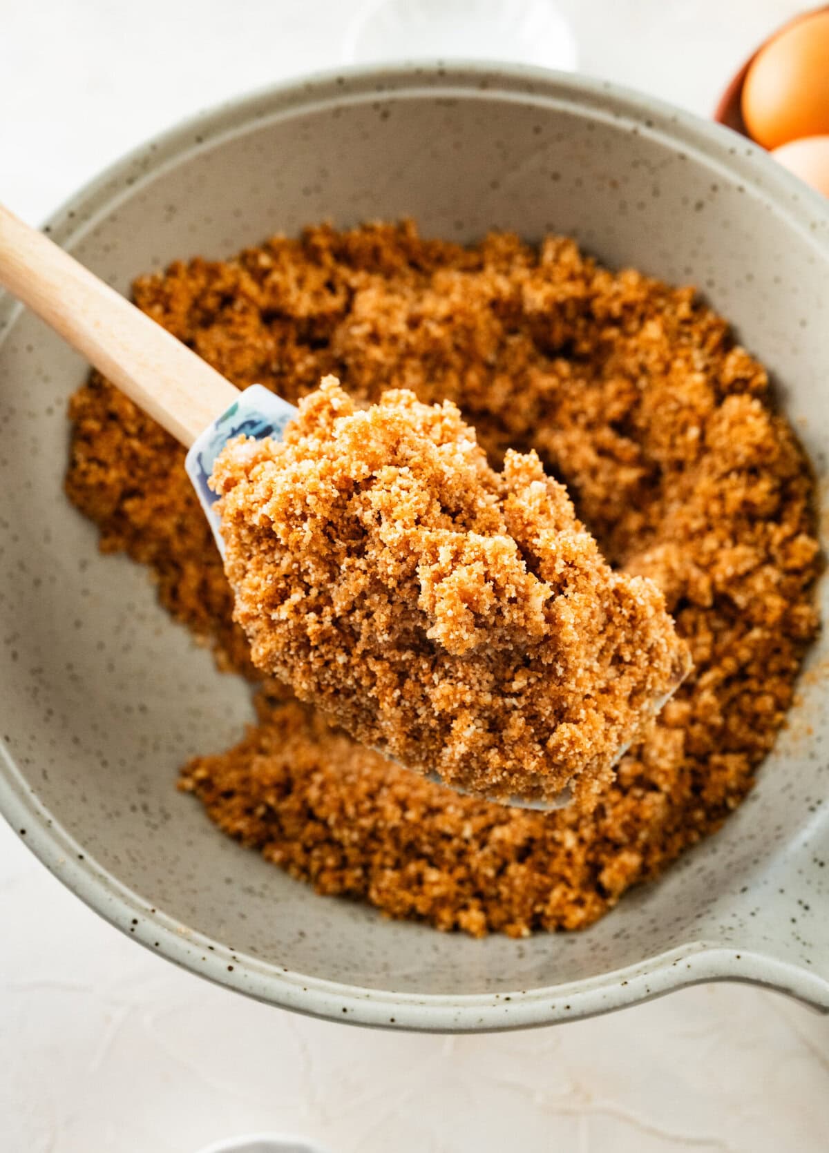 mixing together all of the ingredients to make the ricotta cheesecake crust.