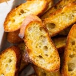 A pile of crostini on a tray.