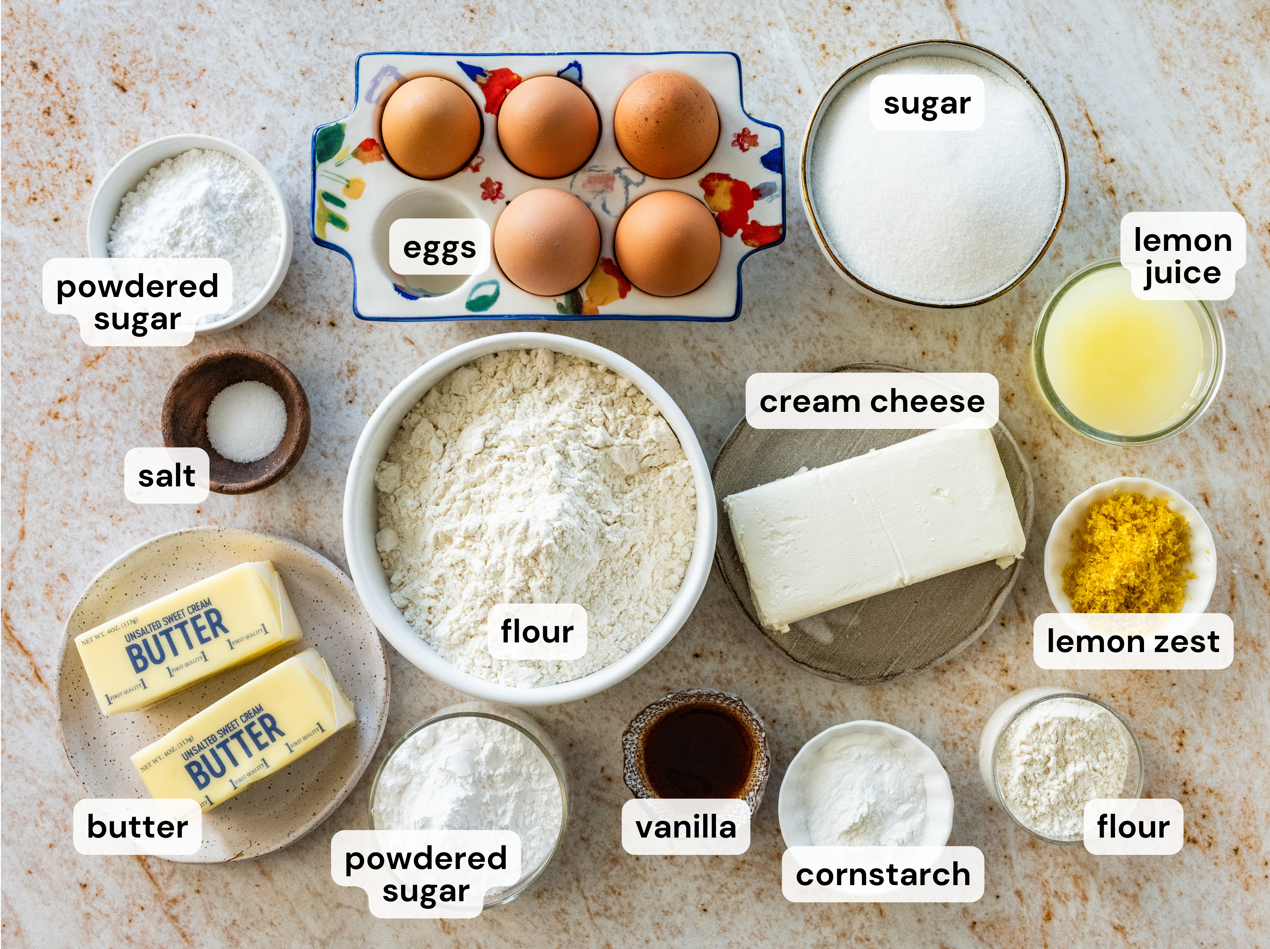 Ingredients to make lemon cream cheese bars in separated bowls.