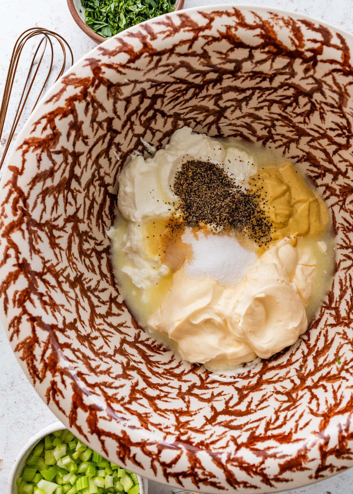 Dressing ingredients in a bowl before combining.