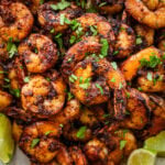 Blackened shrimp on a plate with garnish.