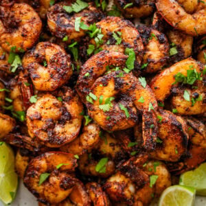 Blackened shrimp on a plate with garnish.