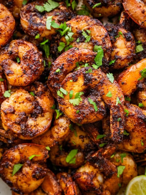 Blackened shrimp on a plate with garnish.