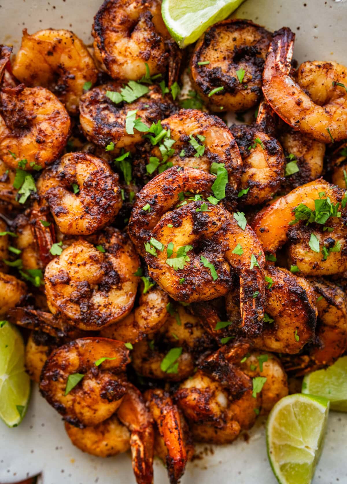 Blackened shrimp on a plate with garnish.