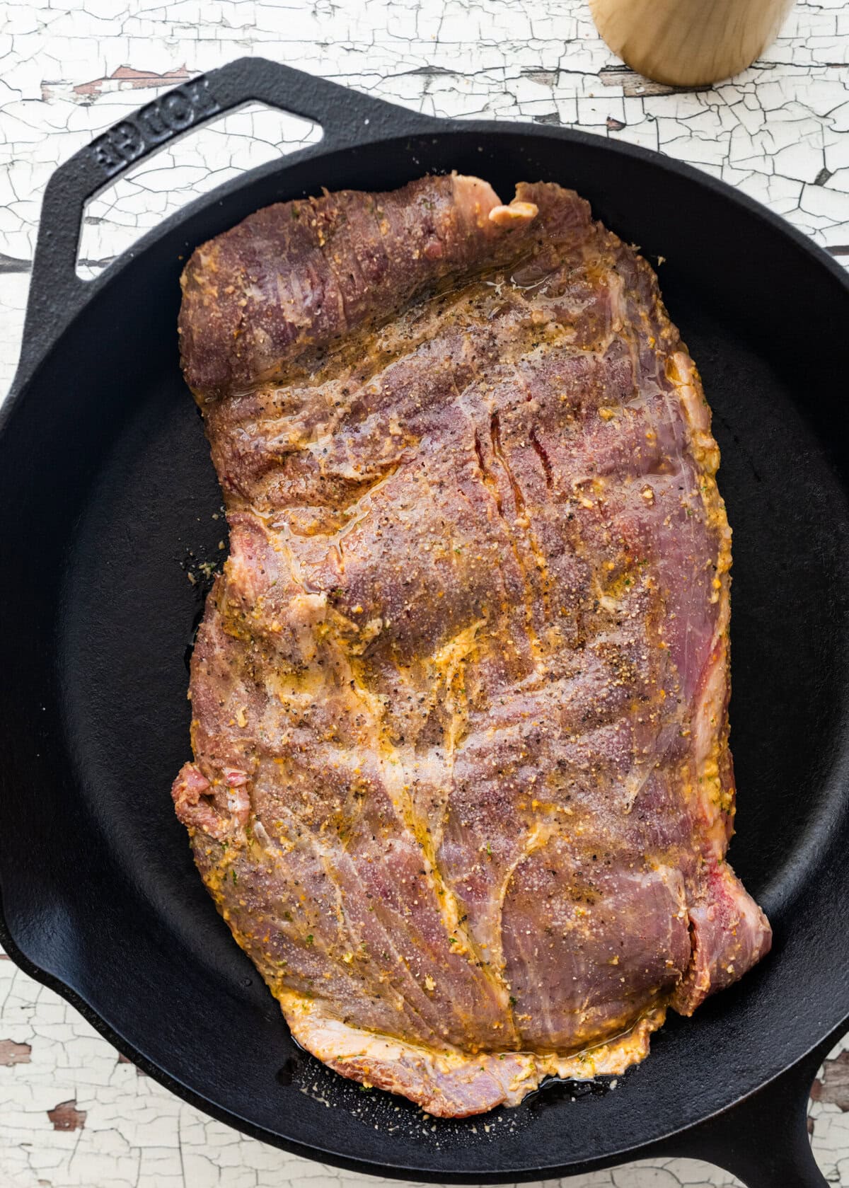Steak placed in a cast iron pan.