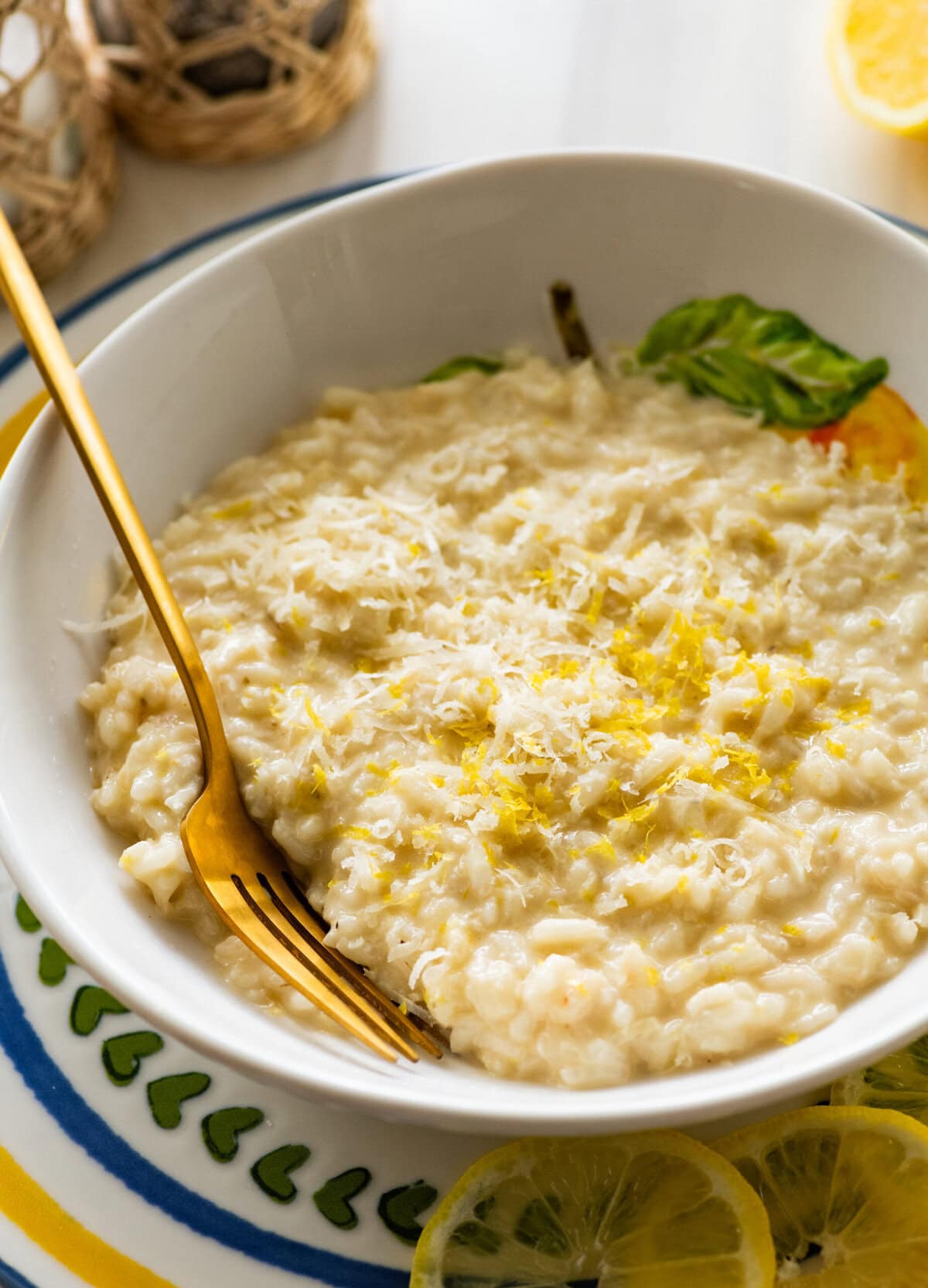 A bowl of lemon risotto with a fork resting in it.