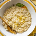A bowl of lemon risotto with a fork resting in it.
