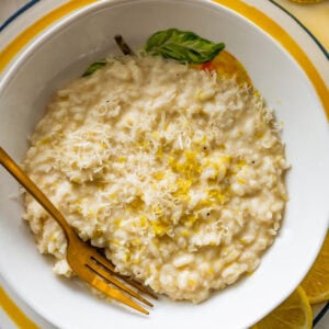 A bowl of lemon risotto with a fork resting in it.