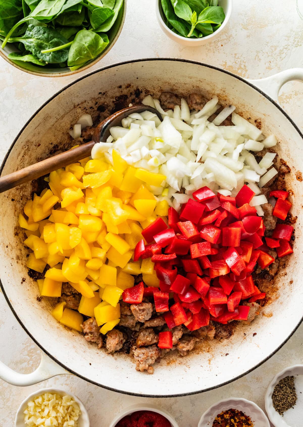 Bell peppers and onions added on top of the cooked sausage.
