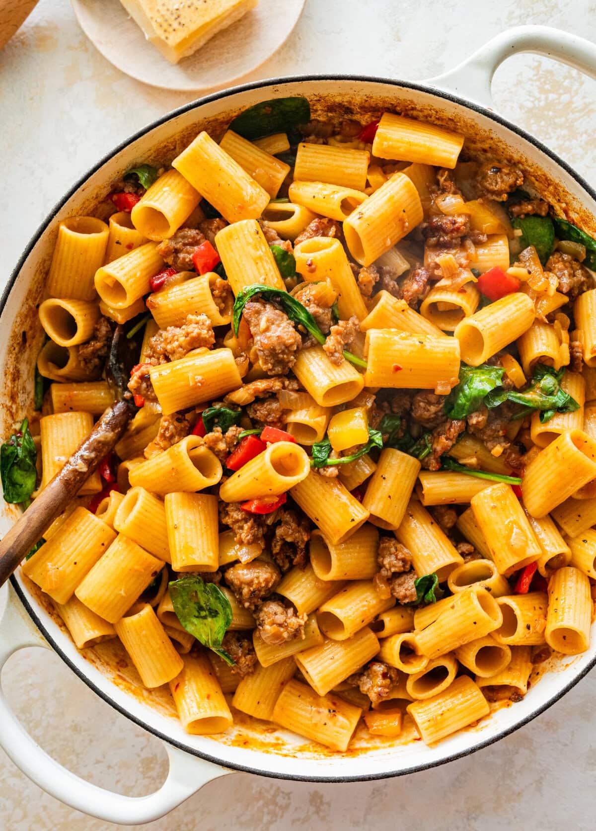 A pot of fully combined sausage and peppers pasta.