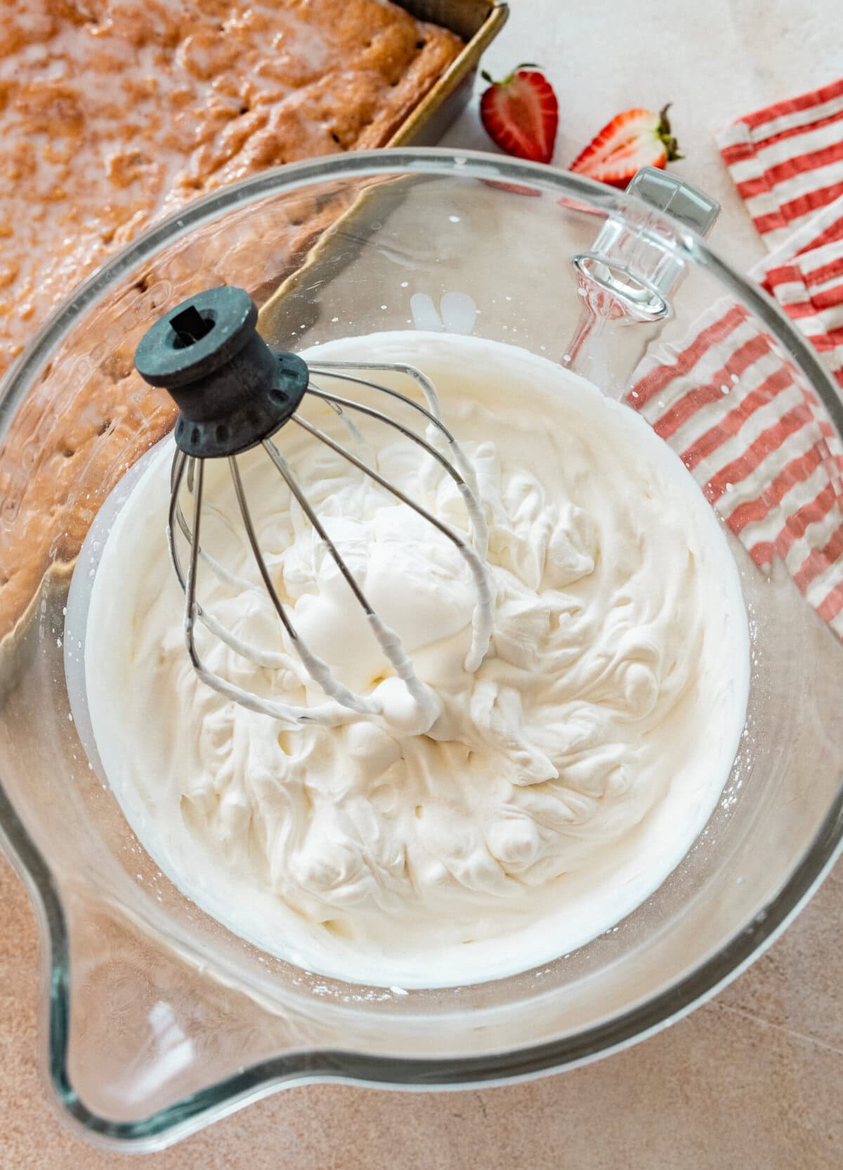 heavy cream, powdered sugar, and vanilla being beaten to form soft peaks.