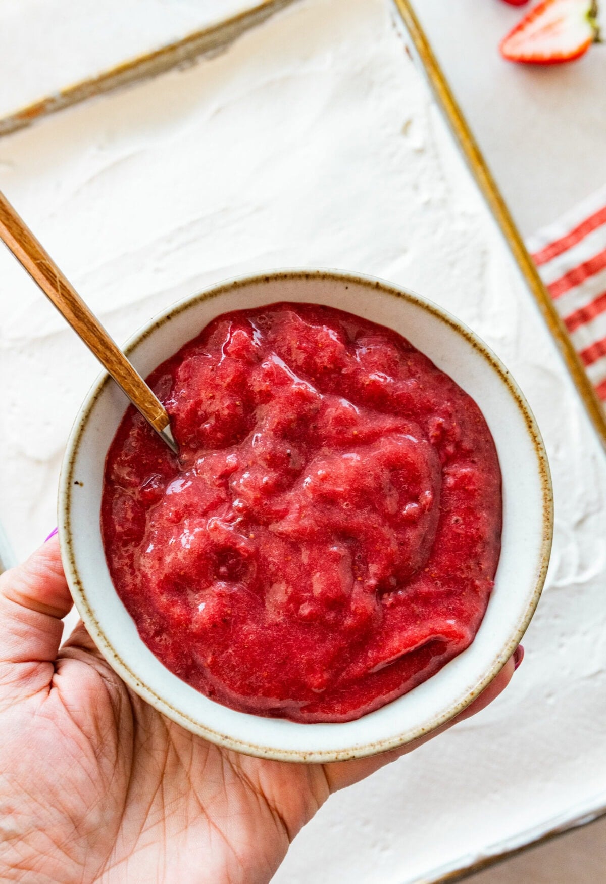 strawberry pur&eacute;e in a bowl with a spoon.