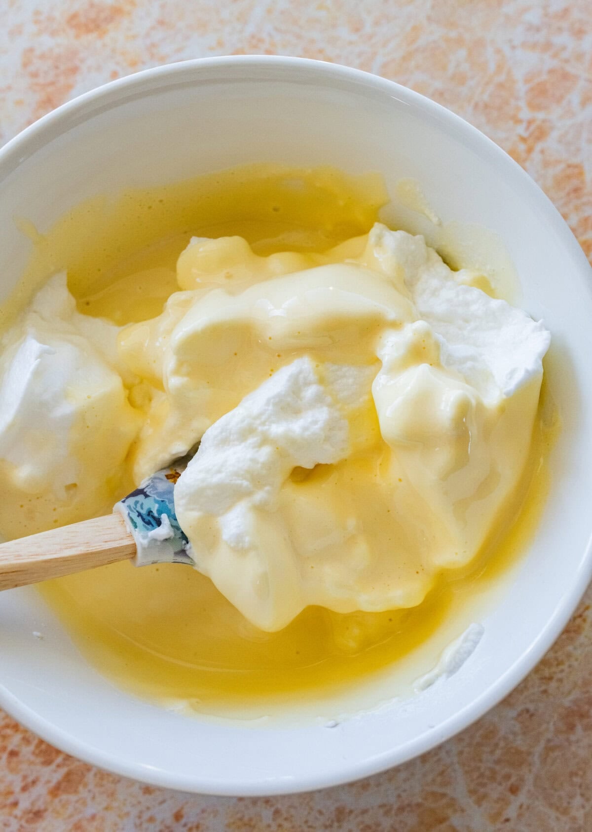 Whites being folded into yolk mixture.