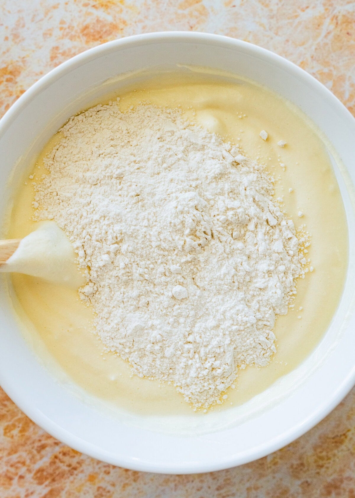 Dry ingredients on top of wet ingredients in bowl.